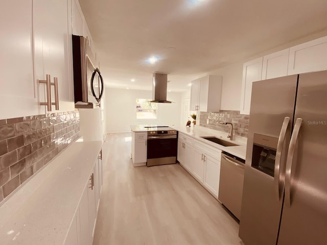 kitchen with island exhaust hood, stainless steel appliances, sink, and white cabinets