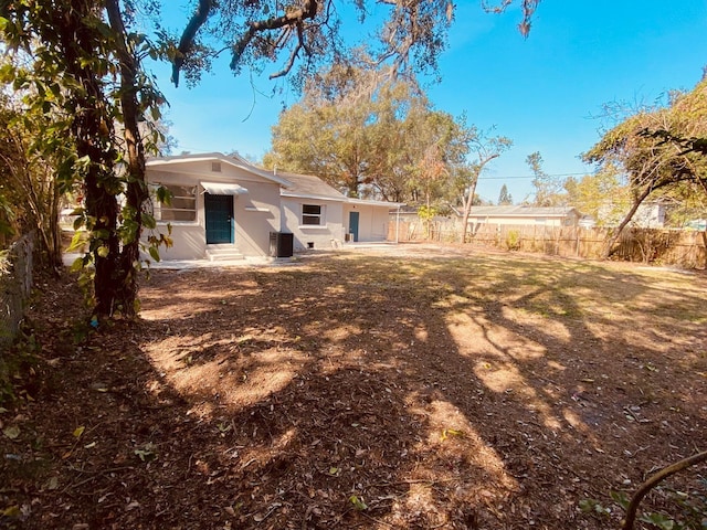 rear view of house with central AC unit