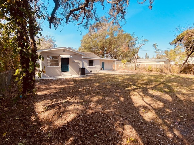 rear view of property with central AC