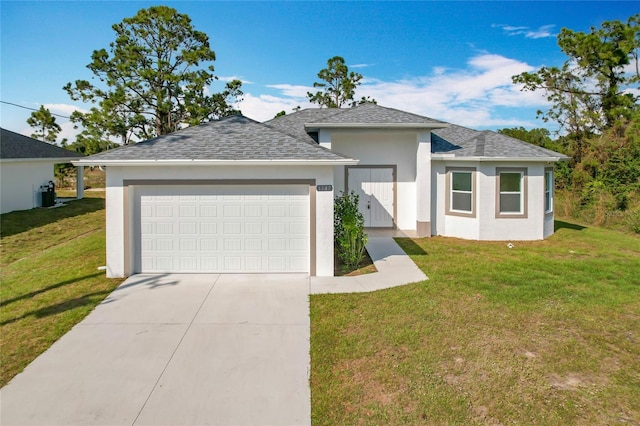 single story home with a garage and a front lawn