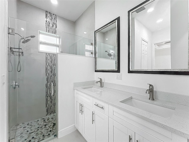 bathroom with vanity and a shower with shower door