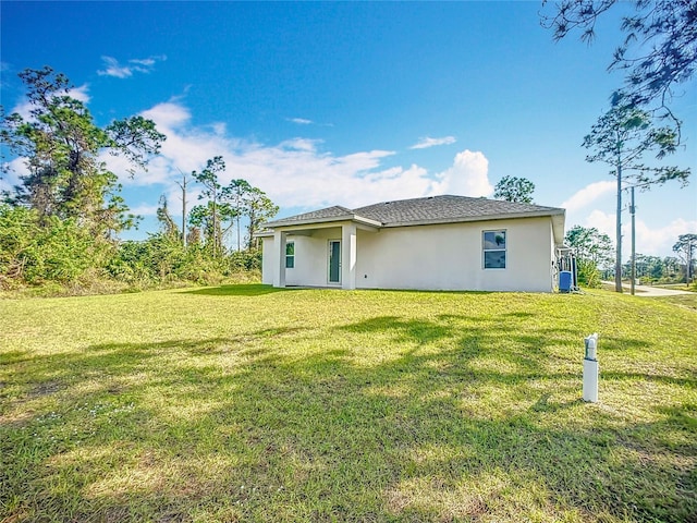 back of property with a lawn