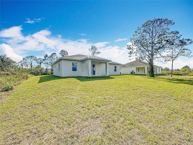 rear view of property featuring a yard