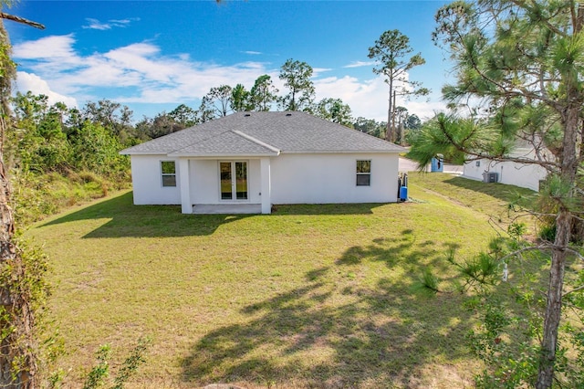 rear view of property featuring a yard