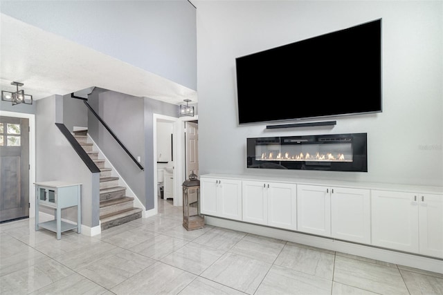 unfurnished living room with a notable chandelier