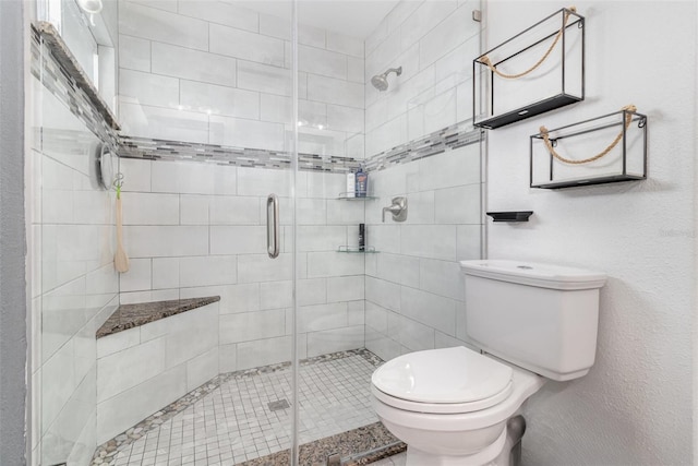 bathroom with toilet and an enclosed shower