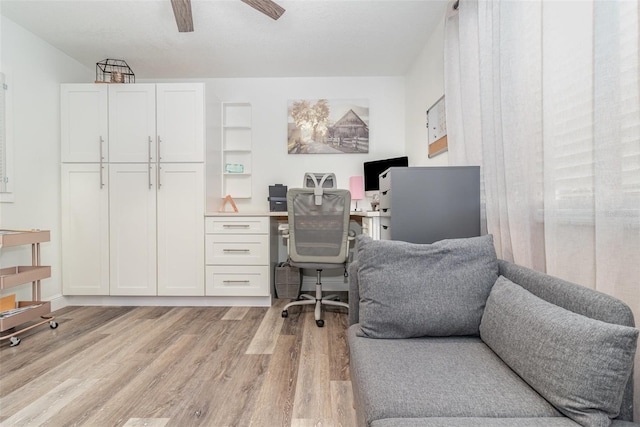 office space with ceiling fan and light wood-type flooring