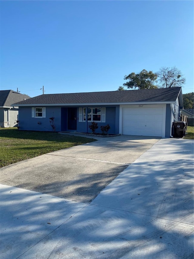 ranch-style house featuring a garage and a front lawn