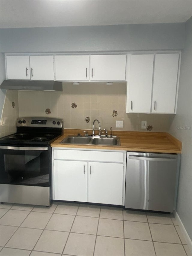 kitchen with tasteful backsplash, white cabinetry, appliances with stainless steel finishes, and sink