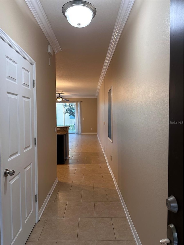 hall with tile patterned flooring and ornamental molding