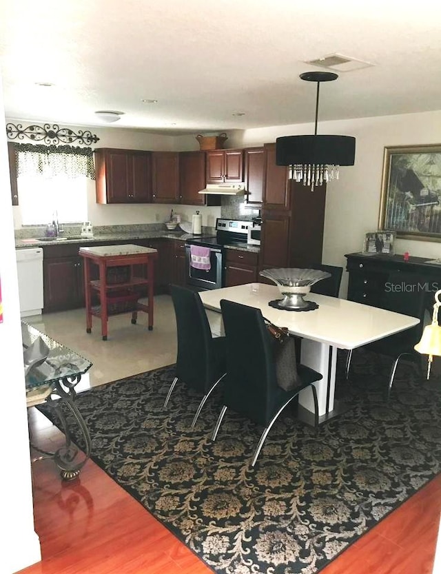 dining space with sink and hardwood / wood-style floors