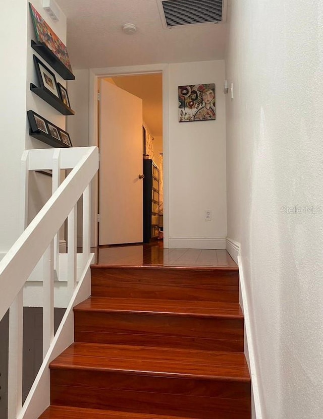 stairway featuring hardwood / wood-style flooring