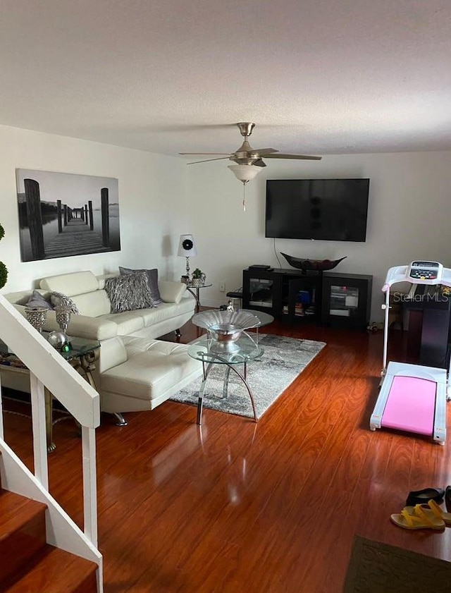 living room with wood-type flooring and ceiling fan