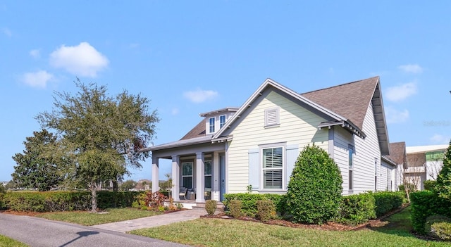 view of front of property with a front yard and a porch