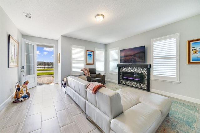 living room with a textured ceiling and a healthy amount of sunlight