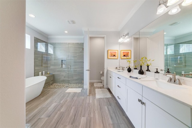 full bathroom with crown molding, shower with separate bathtub, vanity, and toilet