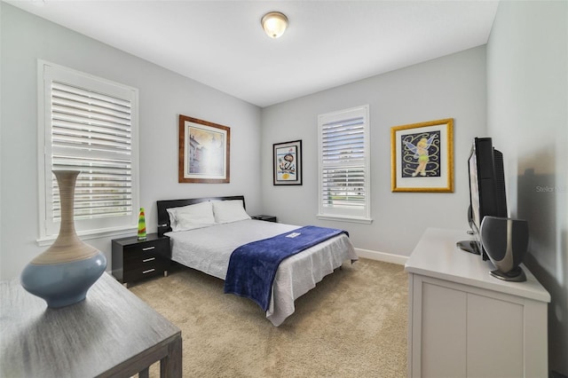 bedroom featuring light carpet