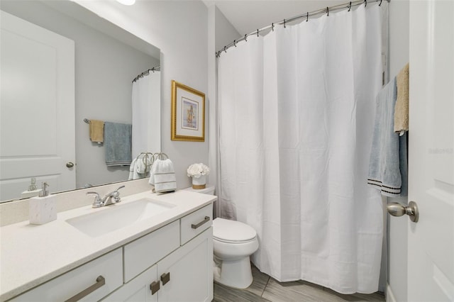 bathroom with vanity, hardwood / wood-style flooring, and toilet