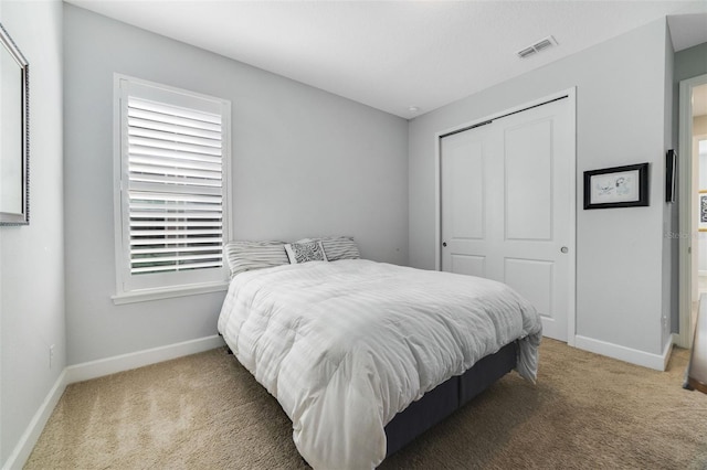 carpeted bedroom featuring a closet