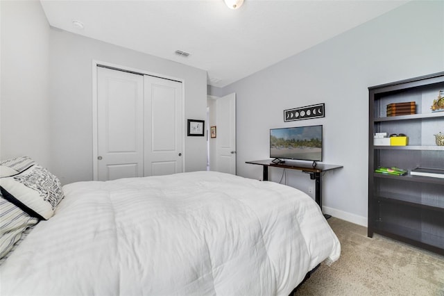 bedroom with light colored carpet and a closet