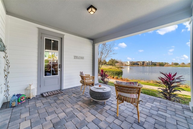 view of patio with a water view