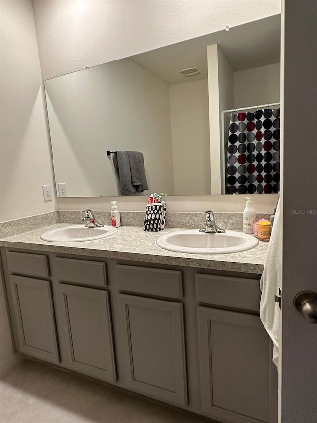 bathroom with vanity and tile patterned floors