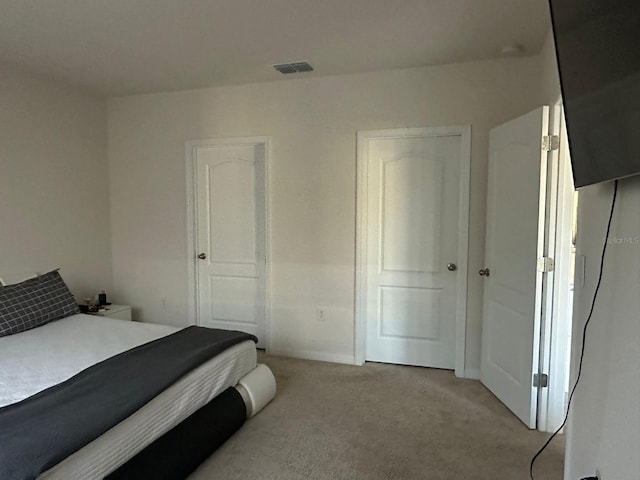 bedroom with light carpet