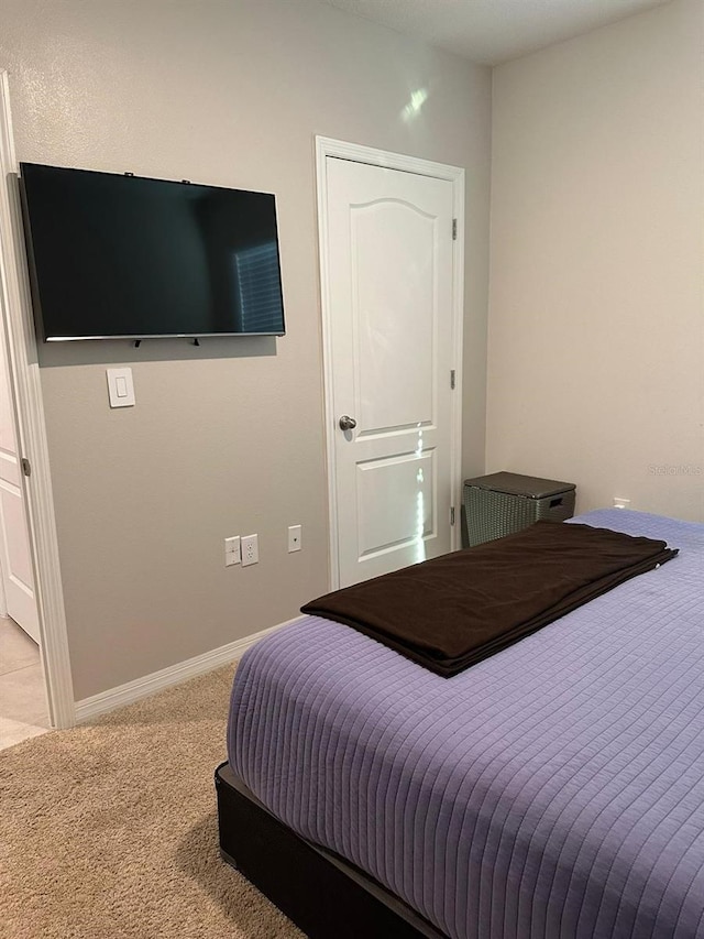 bedroom featuring light carpet