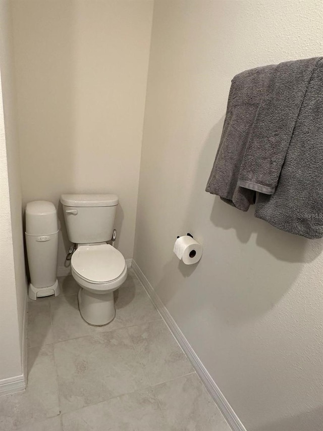 bathroom with tile patterned flooring and toilet