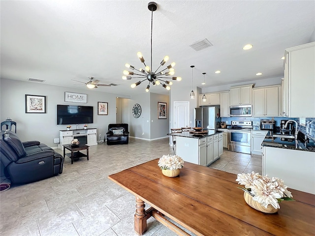 3857 San Isidro Cir, Saint Cloud, FL 34772 - dining room with sink and ceiling fan with notable chandelier