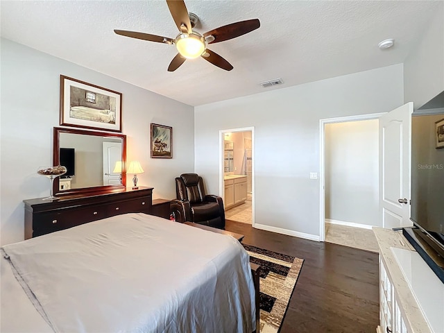 3857 San Isidro Cir, Saint Cloud, FL 34772 - bedroom featuring ceiling fan, light wood-type flooring, a textured ceiling, and ensuite bath
