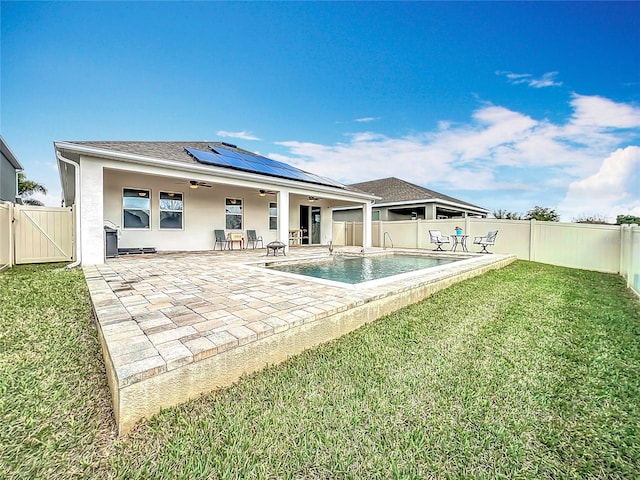 3857 San Isidro Cir, Saint Cloud, FL 34772 - rear view of house with a fenced in pool, a lawn, a patio, and solar panels