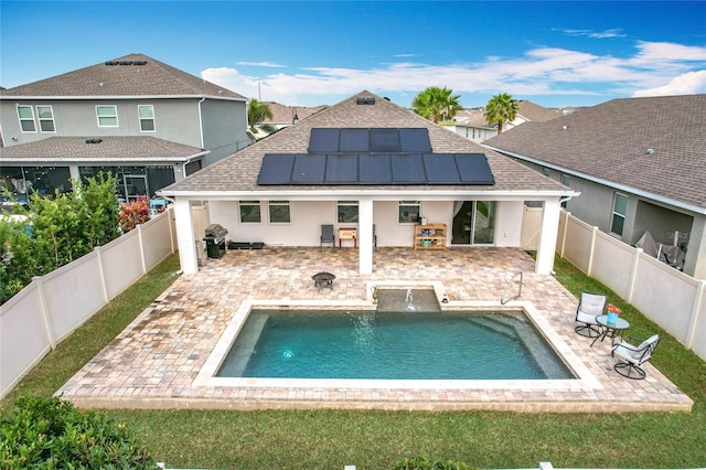 3857 San Isidro Cir, Saint Cloud, FL 34772 - back of house with pool water feature, a fenced in pool, a patio area, and solar panels