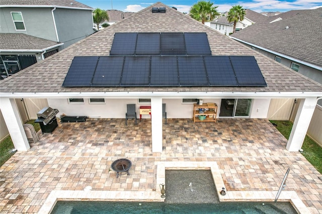 3857 San Isidro Cir, Saint Cloud, FL 34772 - back of property featuring a fire pit and solar panels