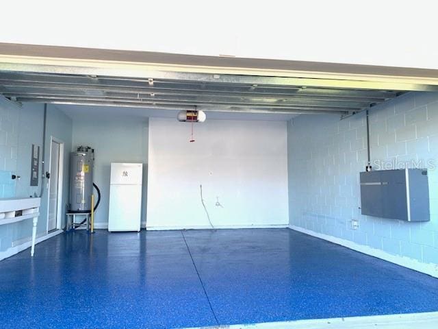 3857 San Isidro Cir, Saint Cloud, FL 34772 - garage with a garage door opener, water heater, and white fridge