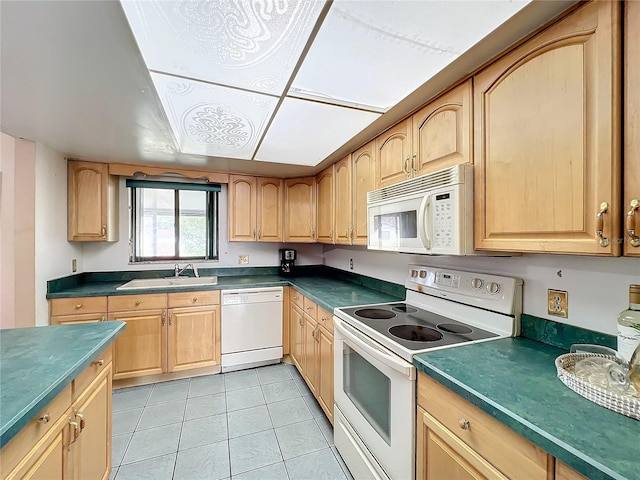 kitchen with light tile patterned flooring, sink, light brown cabinets, and white appliances