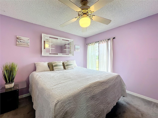 carpeted bedroom featuring ceiling fan and a textured ceiling