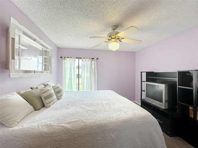 bedroom with ceiling fan and a textured ceiling