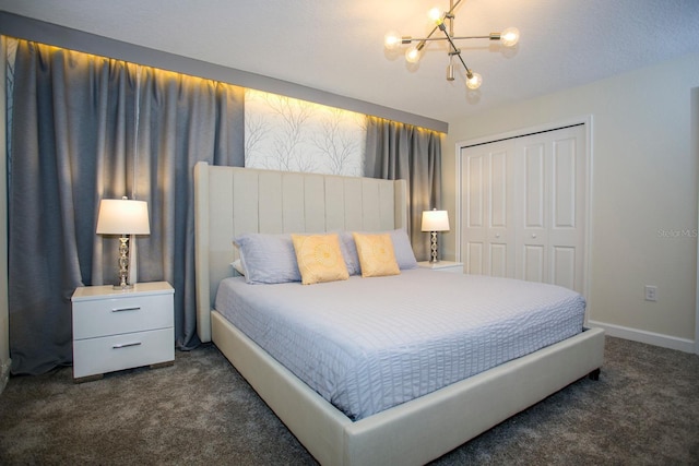 carpeted bedroom with a chandelier and a closet