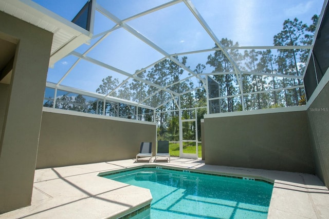 view of pool with a lanai, a mountain view, and a patio area