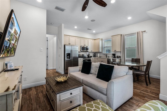 living room featuring dark wood-type flooring, ceiling fan, lofted ceiling, and sink