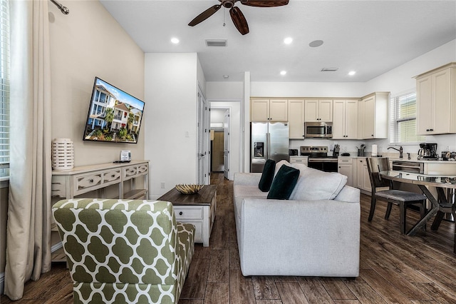 living room with dark hardwood / wood-style floors and ceiling fan