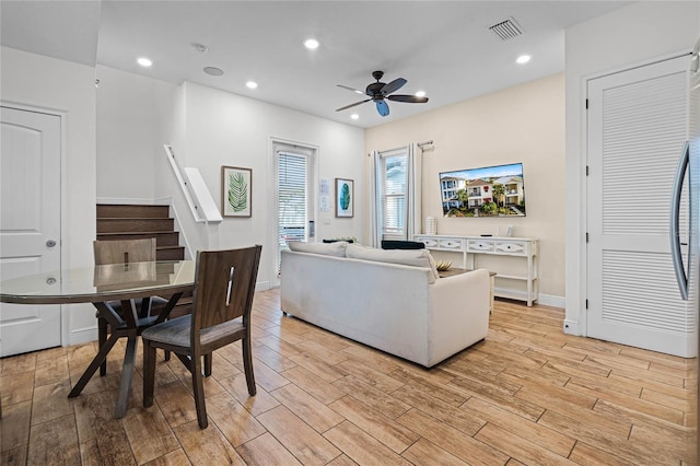 living room featuring ceiling fan and light hardwood / wood-style flooring