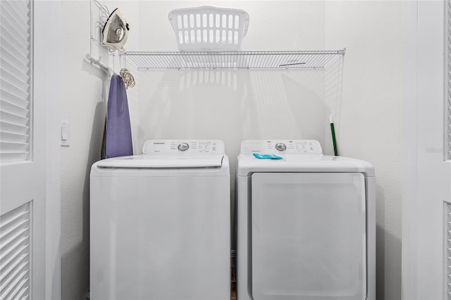 clothes washing area featuring independent washer and dryer