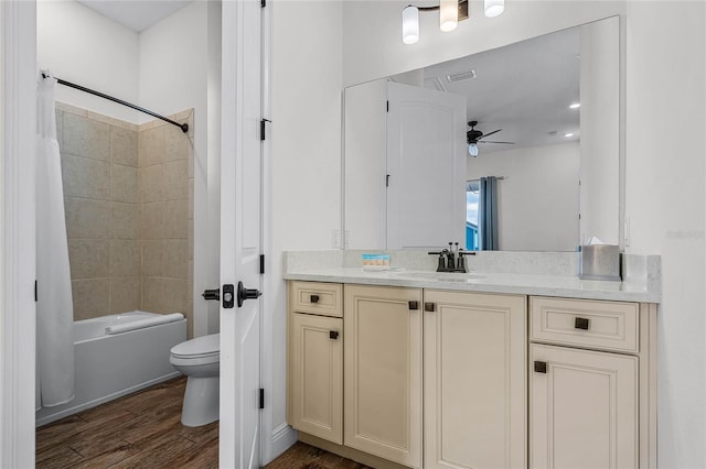 full bathroom with toilet, shower / tub combo, vanity, ceiling fan, and hardwood / wood-style floors