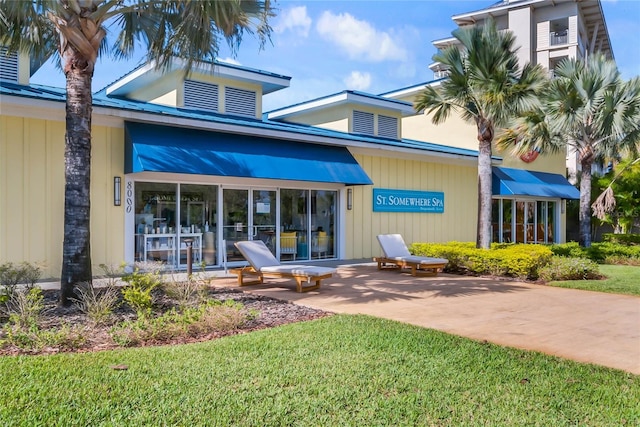 property entrance with a lawn