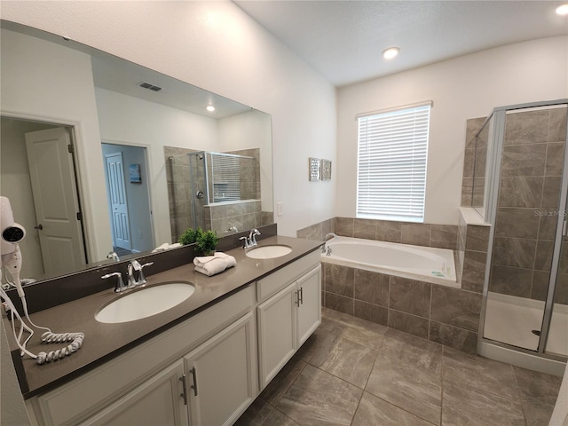 bathroom featuring independent shower and bath and vanity