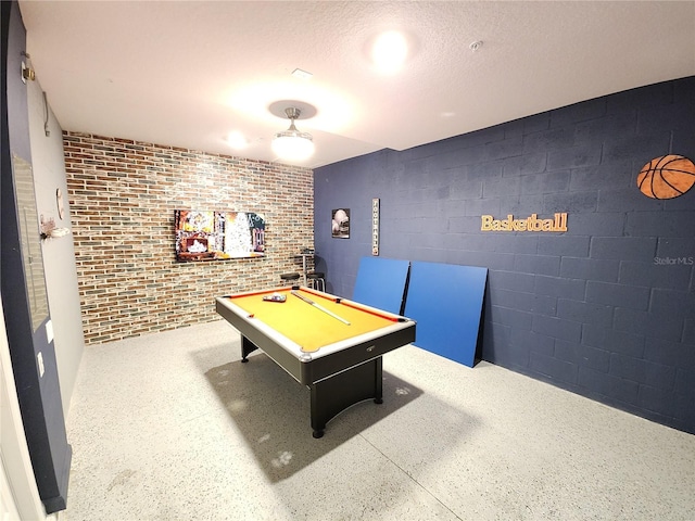 game room featuring billiards and a textured ceiling