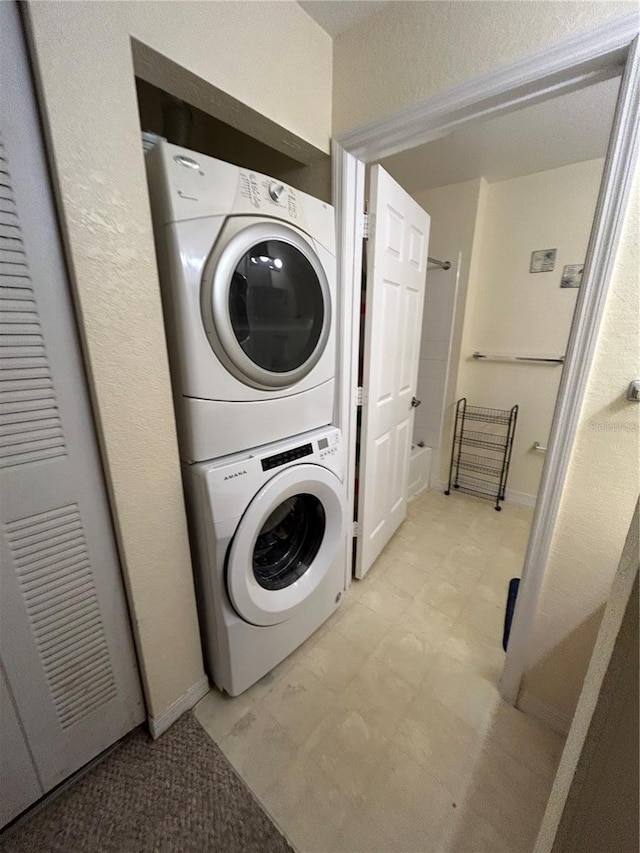 laundry room with stacked washer and dryer