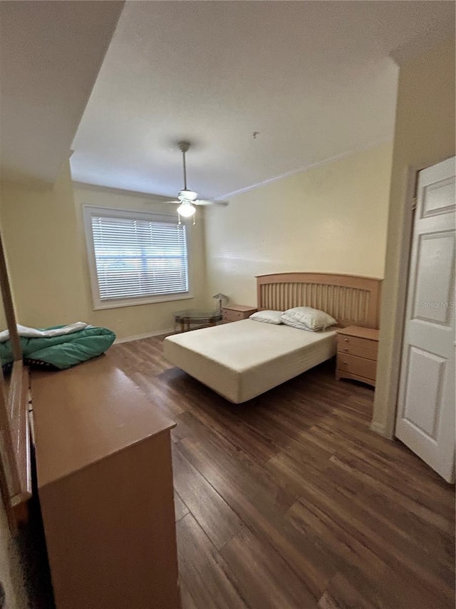 bedroom featuring dark wood-type flooring and ceiling fan